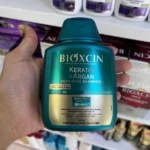 شامپو ترمیم کننده بیوکسین حاوی آرگان و کراتین بدون پارابن حجم ۳۰۰ میل